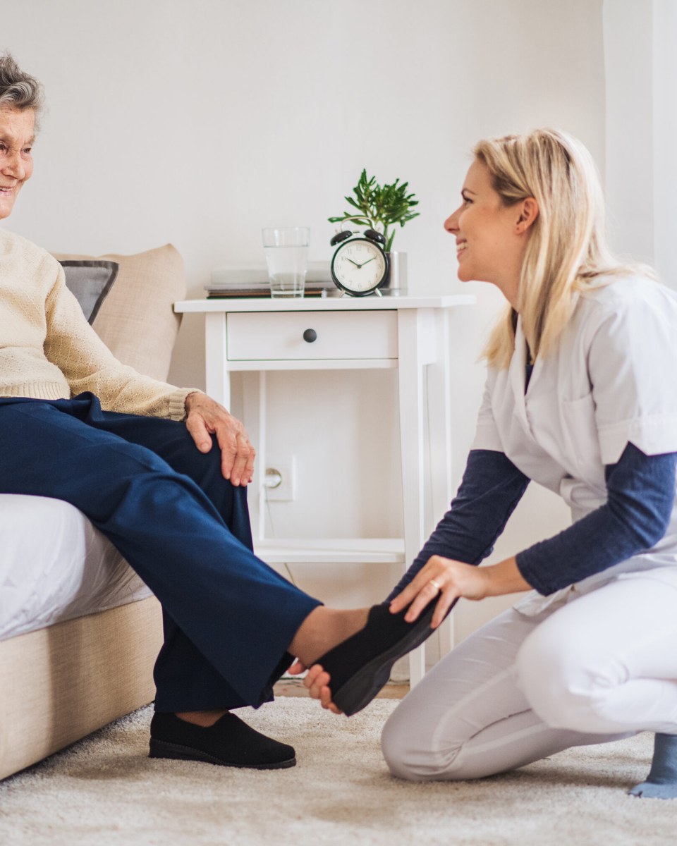 Nestcura caregiver helping a client at home